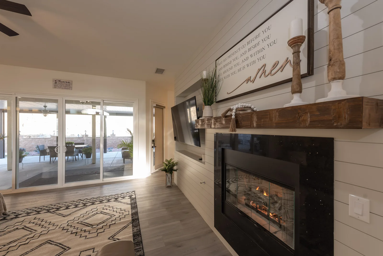 Living room with fireplace and shiplap wall at Manitou Home in Corona, California