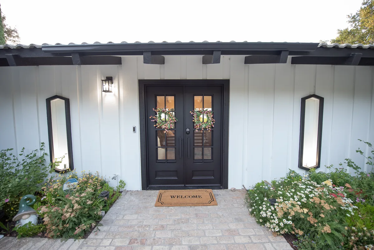 Front entrance with double doors and a welcome mat at Ohana Excellence Crown Ranch, Corona, California